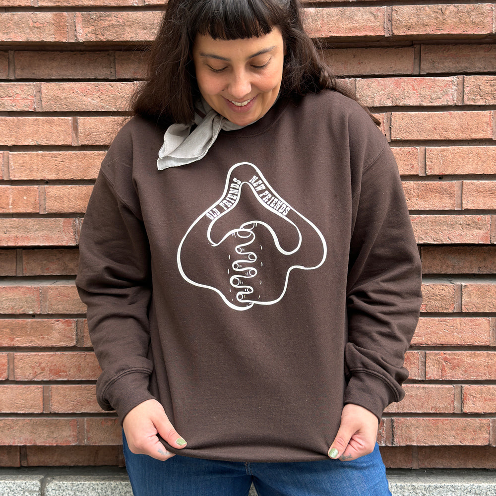 Lifestyle photograph of a woman wearing the sweatshirt.