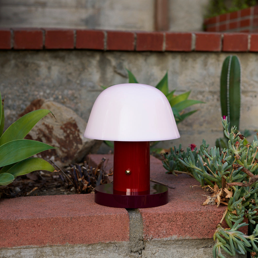 Portable lamp on brick planter.