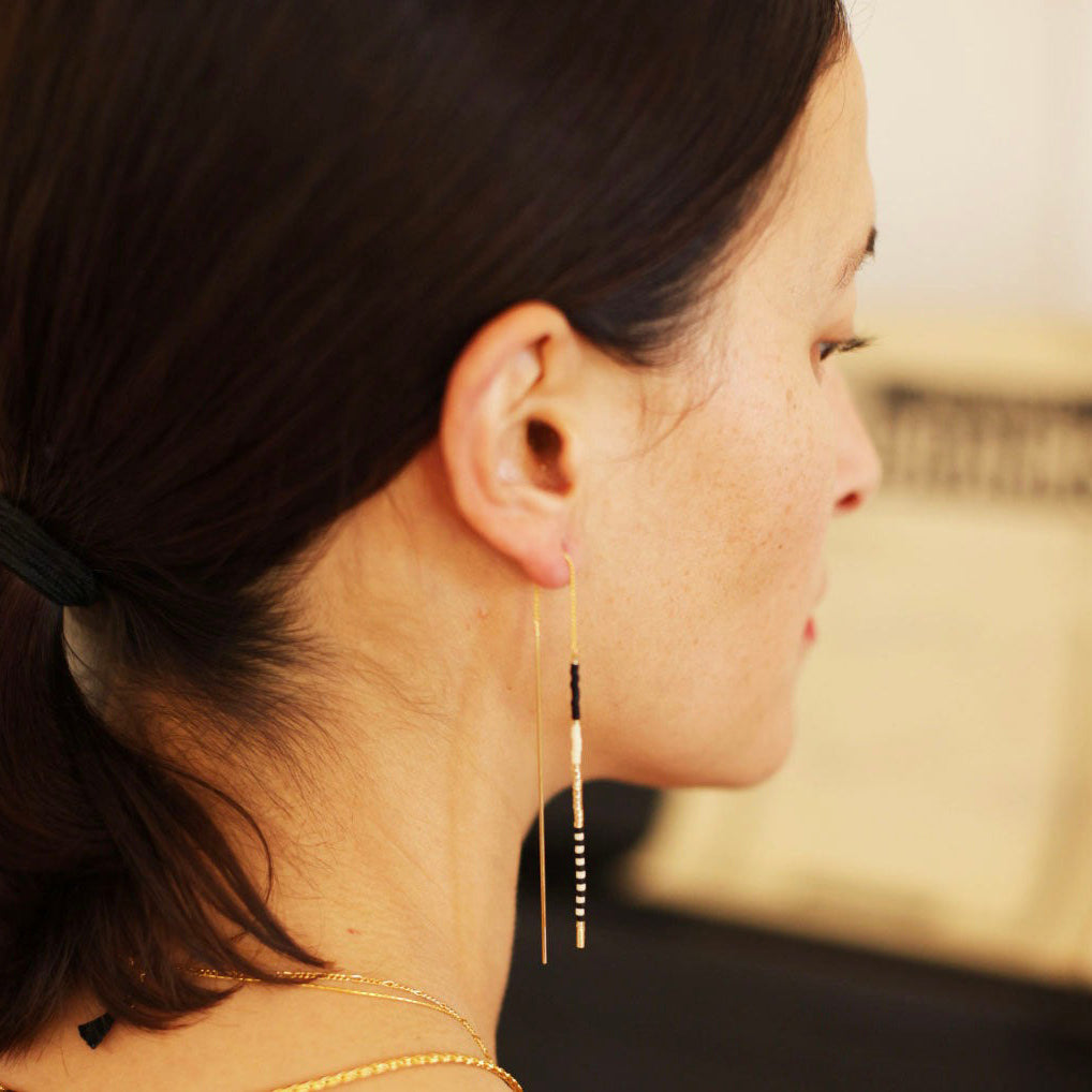 Threader earrings on display.