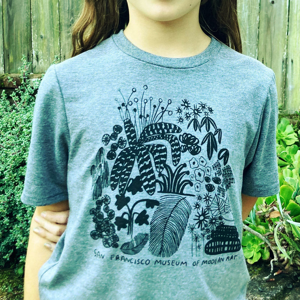 Carissa Potter x SFMOMA Kids t-shirt on a child in a garden close-up.