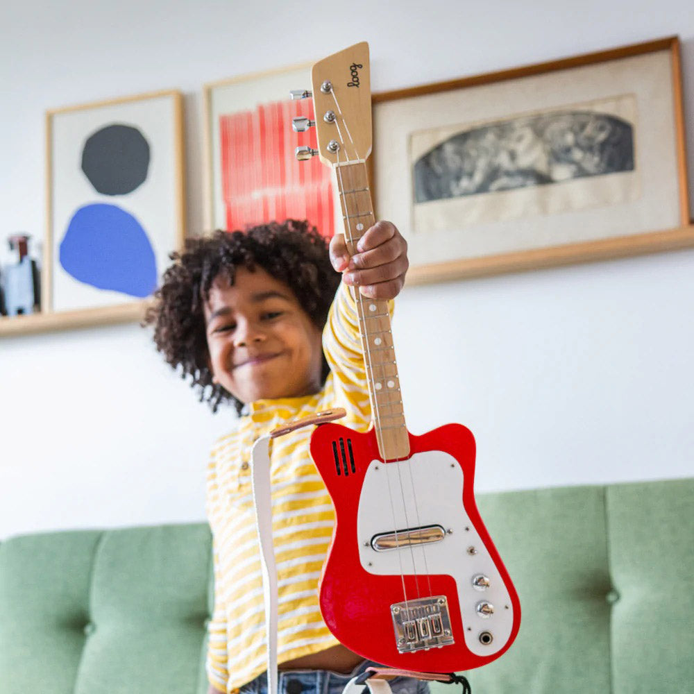 Kid model holding up guitar.