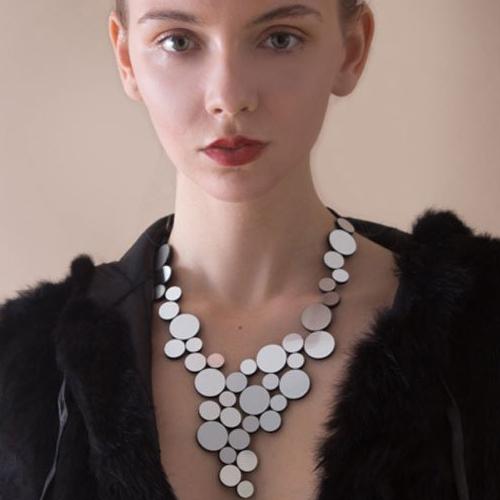 The Iskin Sisters: Silver Abstraction Necklace worn by a model.