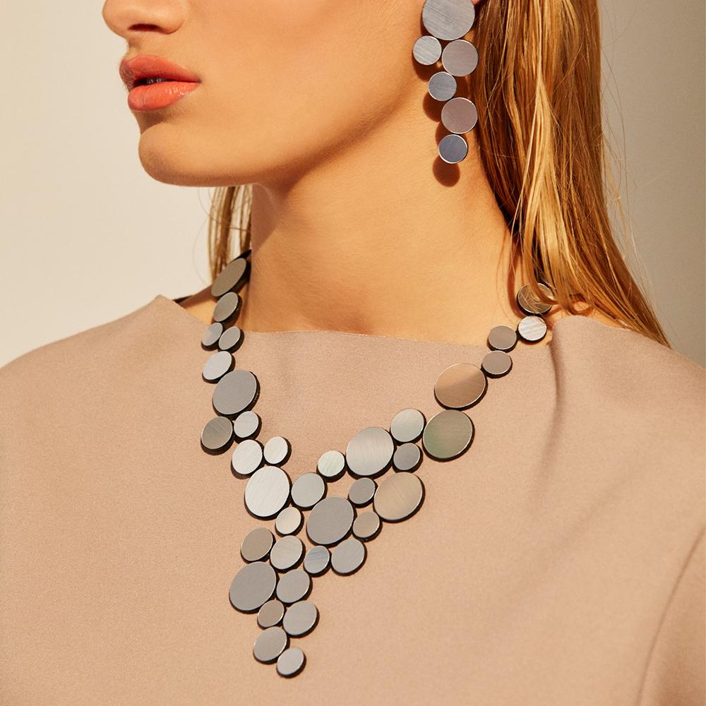 Close up of Iskin Sisters: Silver Abstraction Necklace worn by a model.