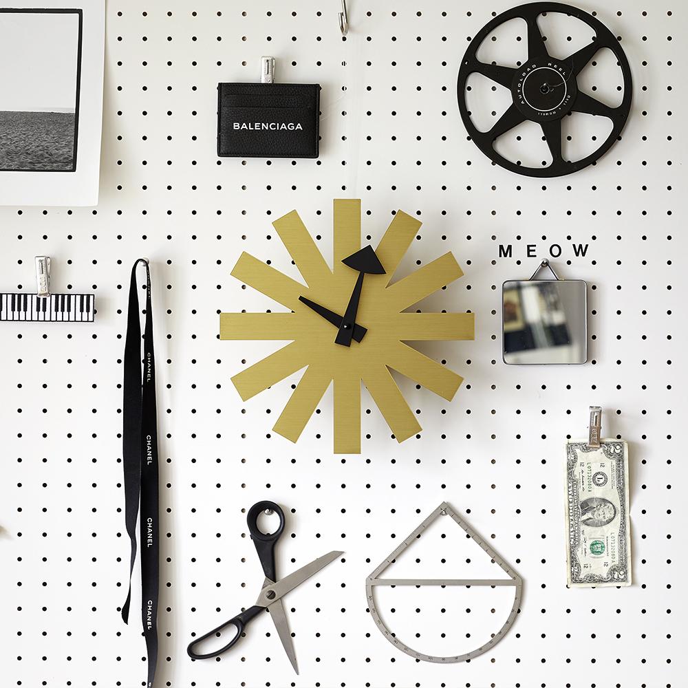 Asterisk Clock displayed on a wall with tools.