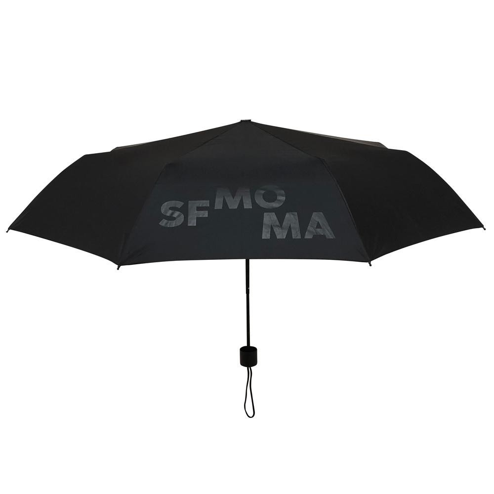 Black top of the SFMOMA Black and Gold Umbrella with the museums logo displayed.