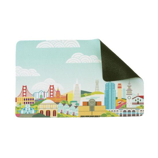 SFMOMA x Andrew Holder Cityscape Travel Mousepad with top corner folded back to show rubber base.