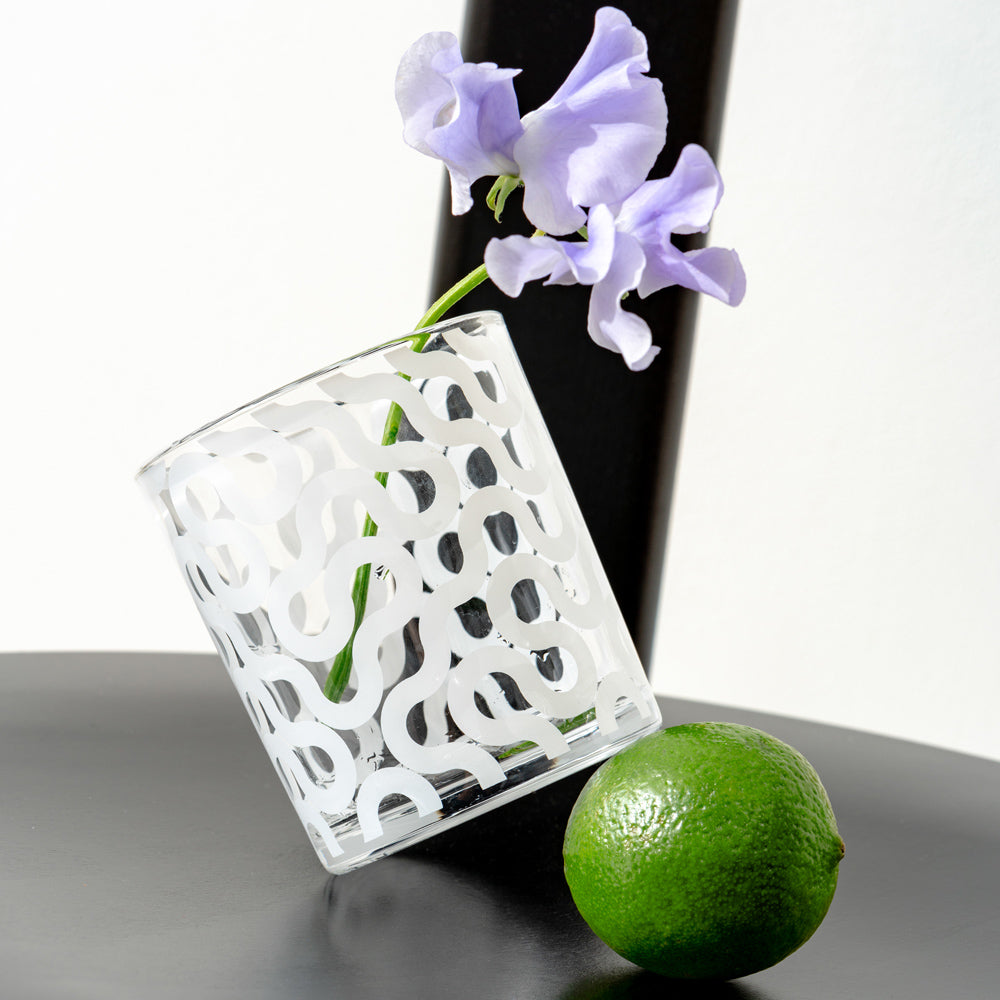 A pattern glass with a flower inside.