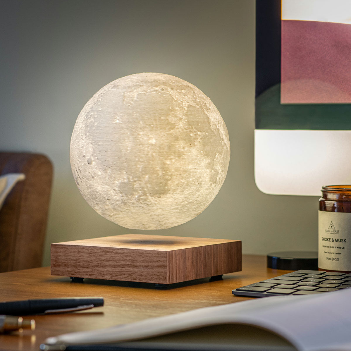 A Smart Moon Lamp: Walnut displayed on desk on its &quot;yellow warm&quot; setting.