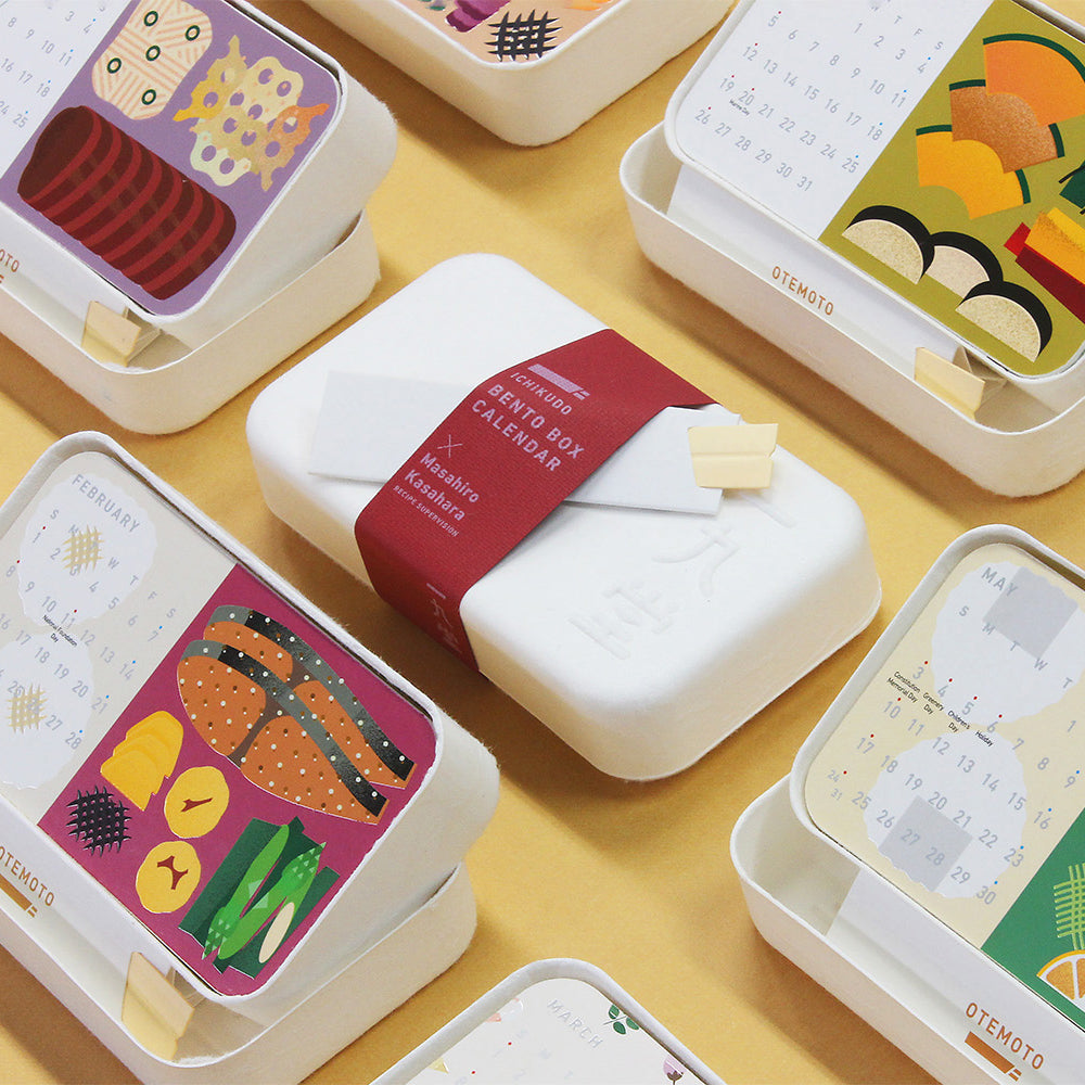 Collection of small, colorful calendars with printed designs on a yellow surface