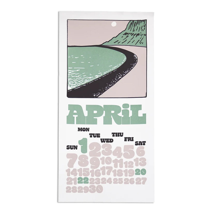 A vertical wall calendar page for April with a minimalist illustration of a curved road between green hills and a pale pink sky above a monthly calendar grid. The word APRIL is printed in large mint-green letters, with days of the week in black and numbers in muted pink, green, and black on a white page.