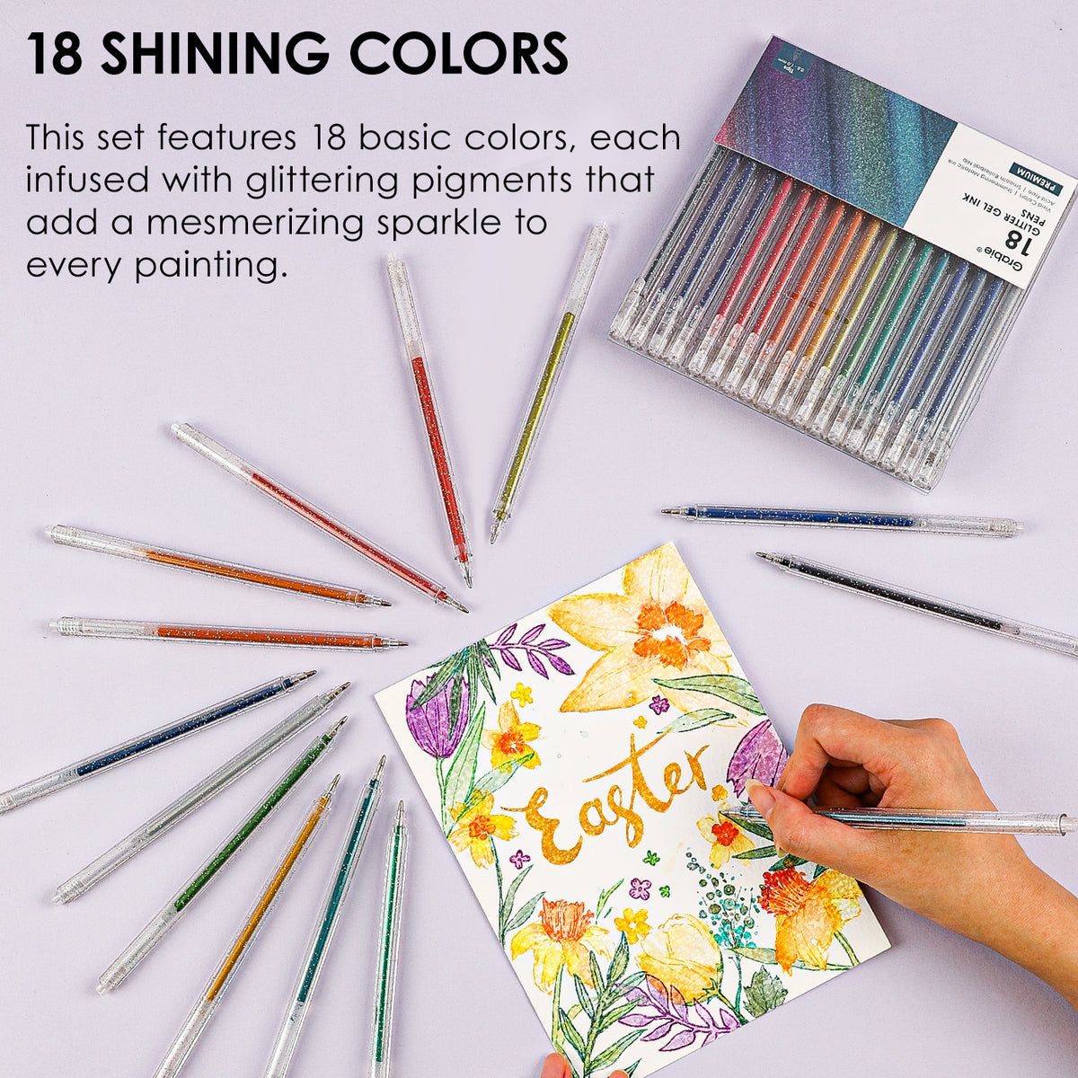 Set of 18 watercolor pens with a hand painting an Easter-themed card on a light background.