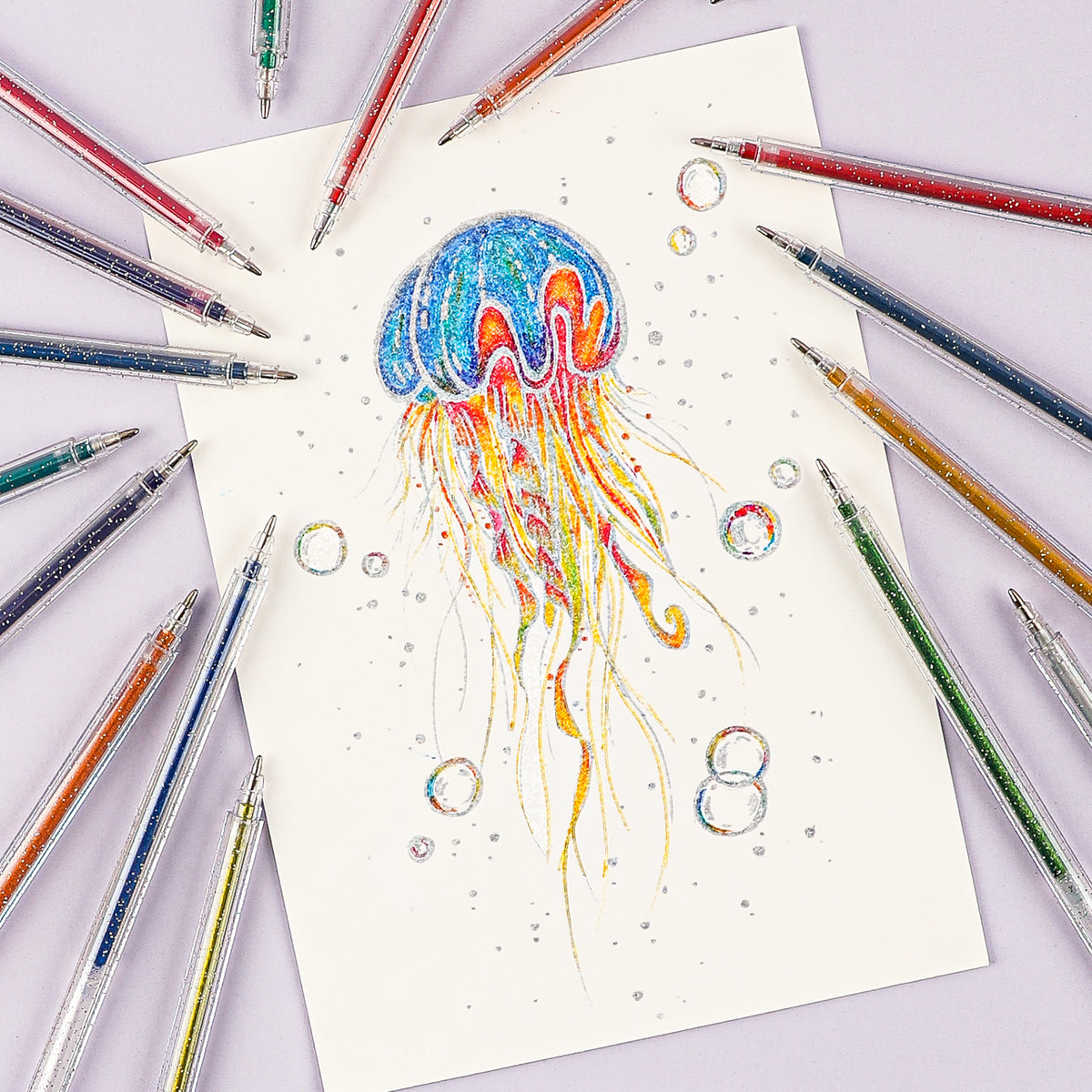 Colorful jellyfish drawing on paper with glittery pens around