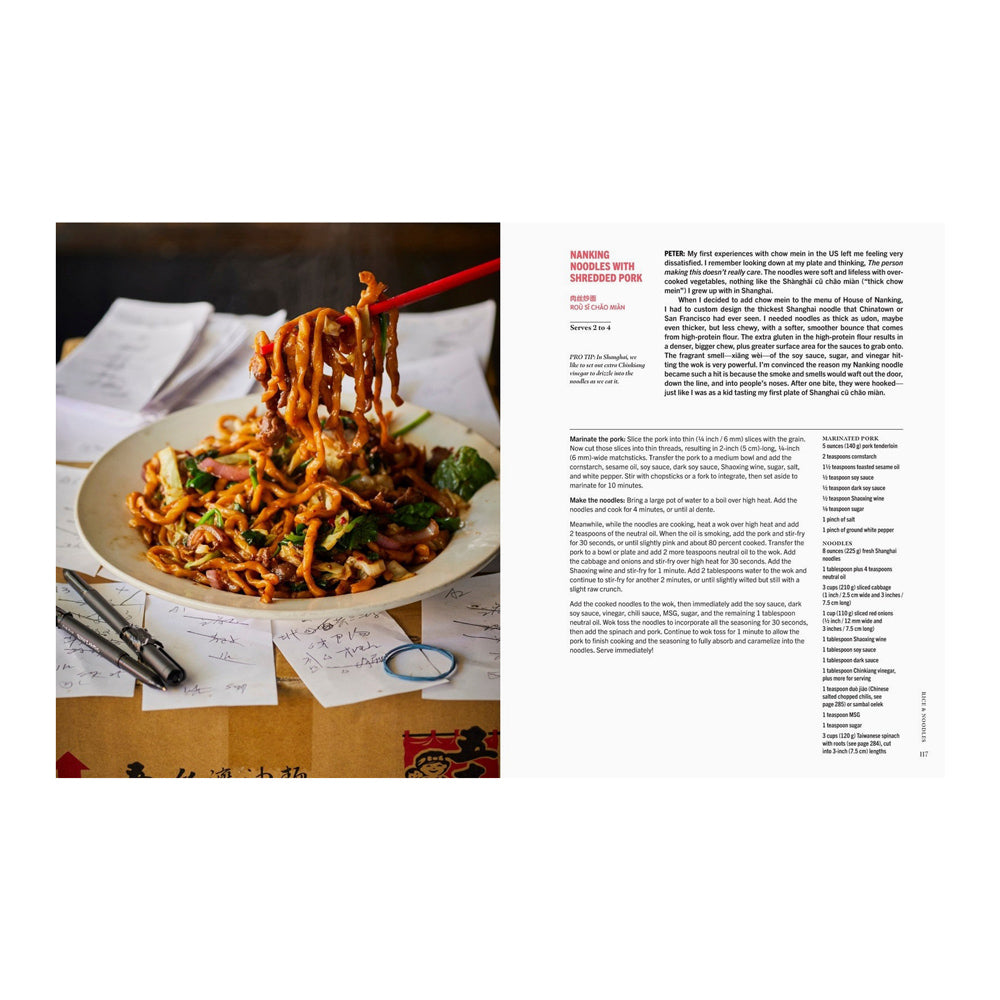 Interior pages featuring text and a photograph of noodles with vegetables on a plate with chopsticks, placed on a table with papers and a pen.