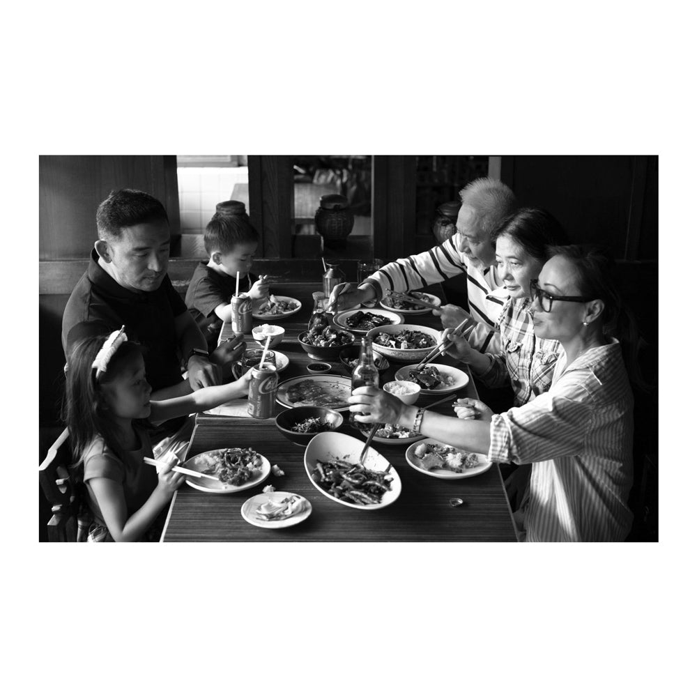 Interior pages featuring a black and white photo of a family dining together at a table with plates and cutlery.