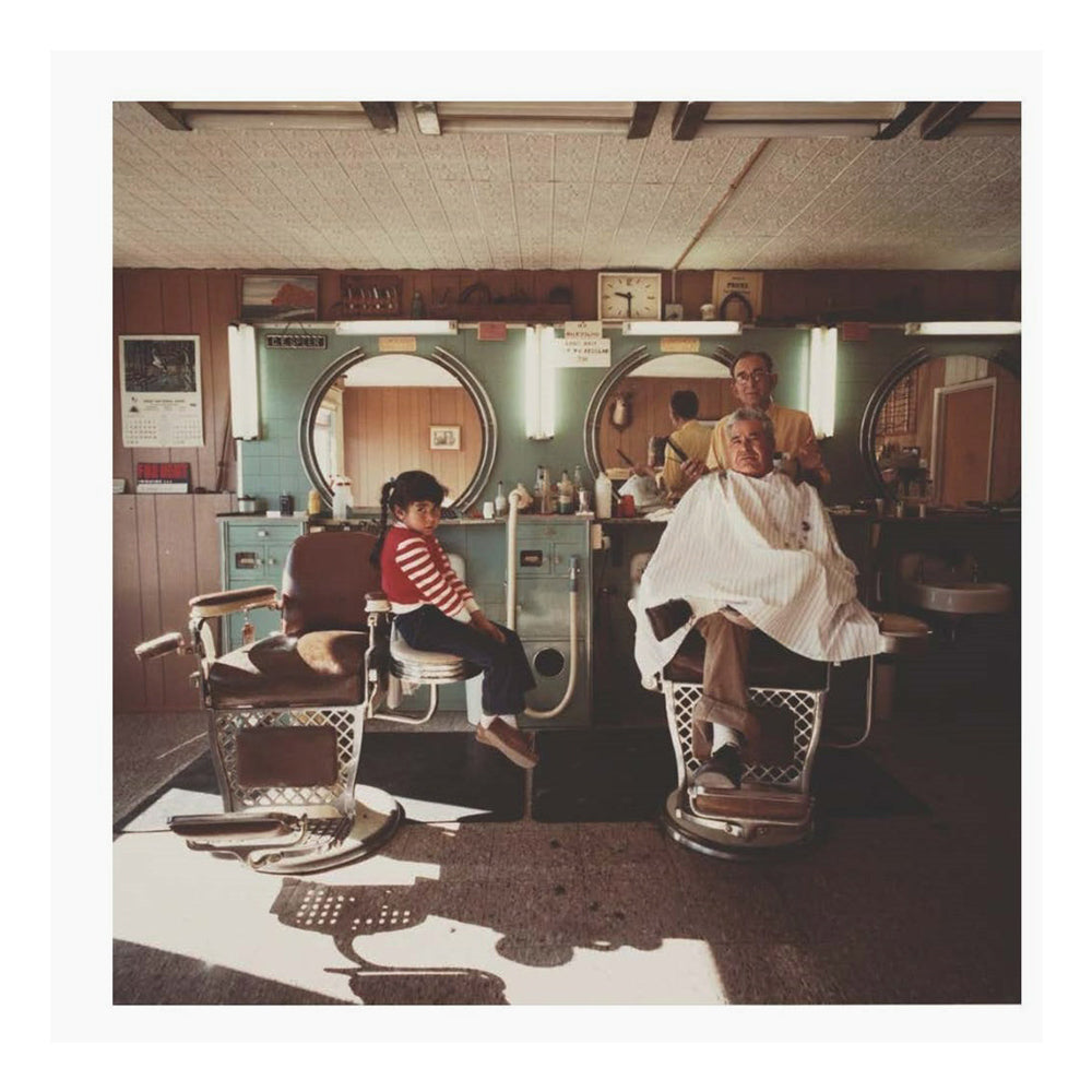 Photograph of people in a barbershop.