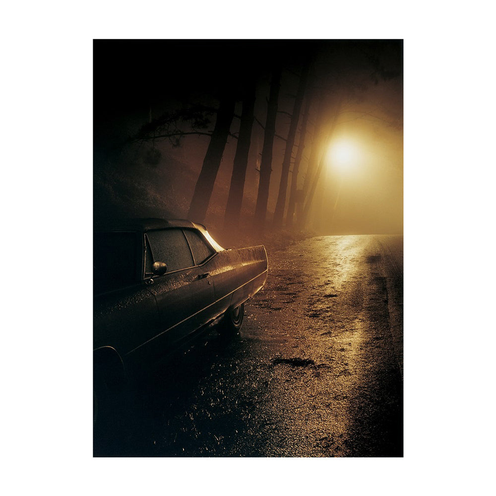 Interior page featuring photograph of vintage car on a foggy road with a bright light in the distance.
