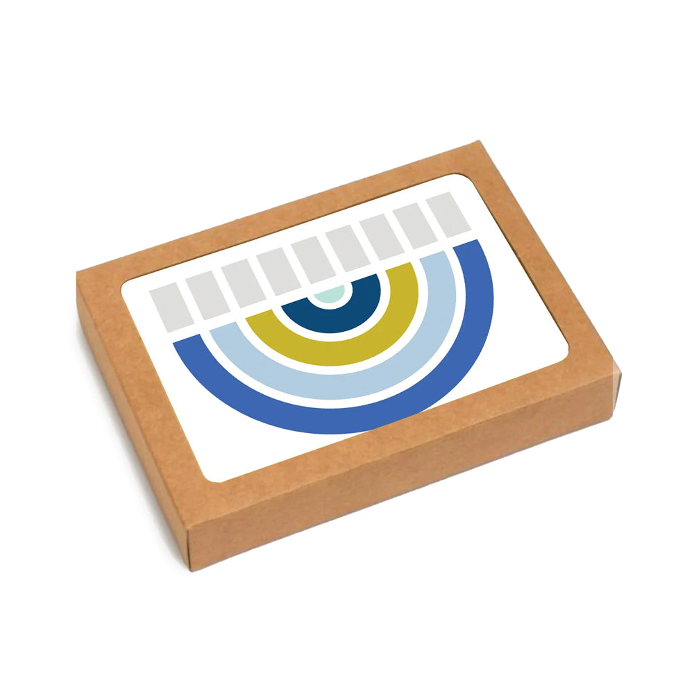 A square brown kraft paper box with a clear window on top, displaying a colorful circular arch graphic in blue, light blue, yellow, and dark blue on a white background.