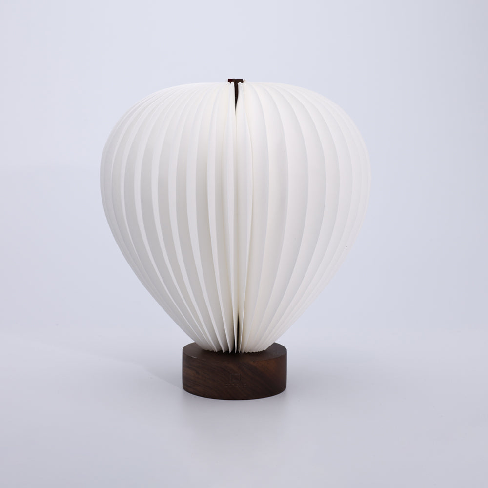 White lamp with wooden base on a light gray background