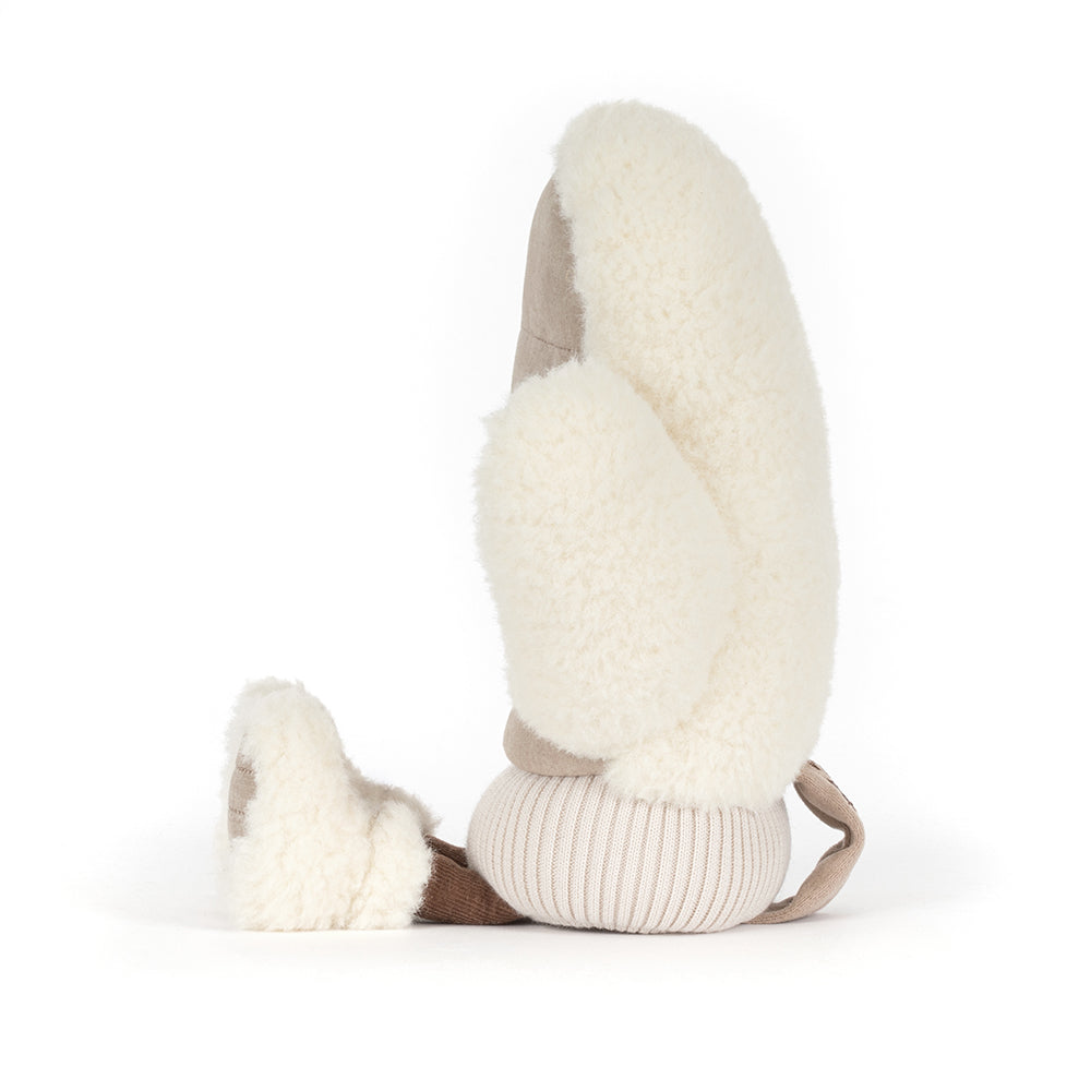 A plush sheepskin bootie pillow in cream and beige, shown from a side profile on a white background.