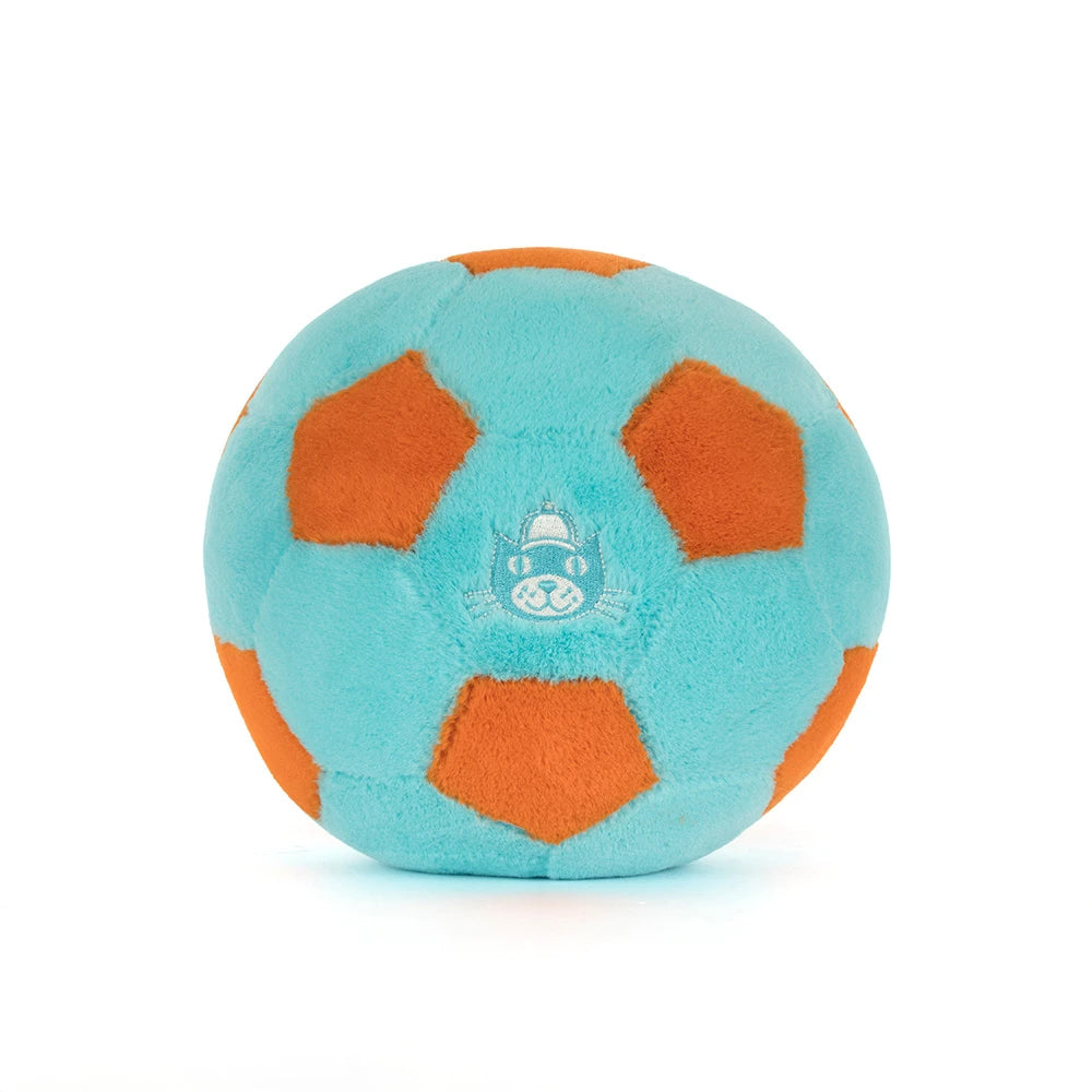 Rear view; plush toy resembling a soccer ball with orange panels on a white background