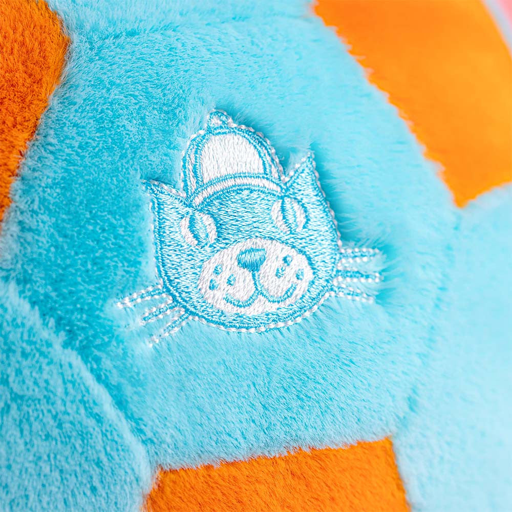 Close-up of a plush toy with Jellycat logo on a blue and orange background