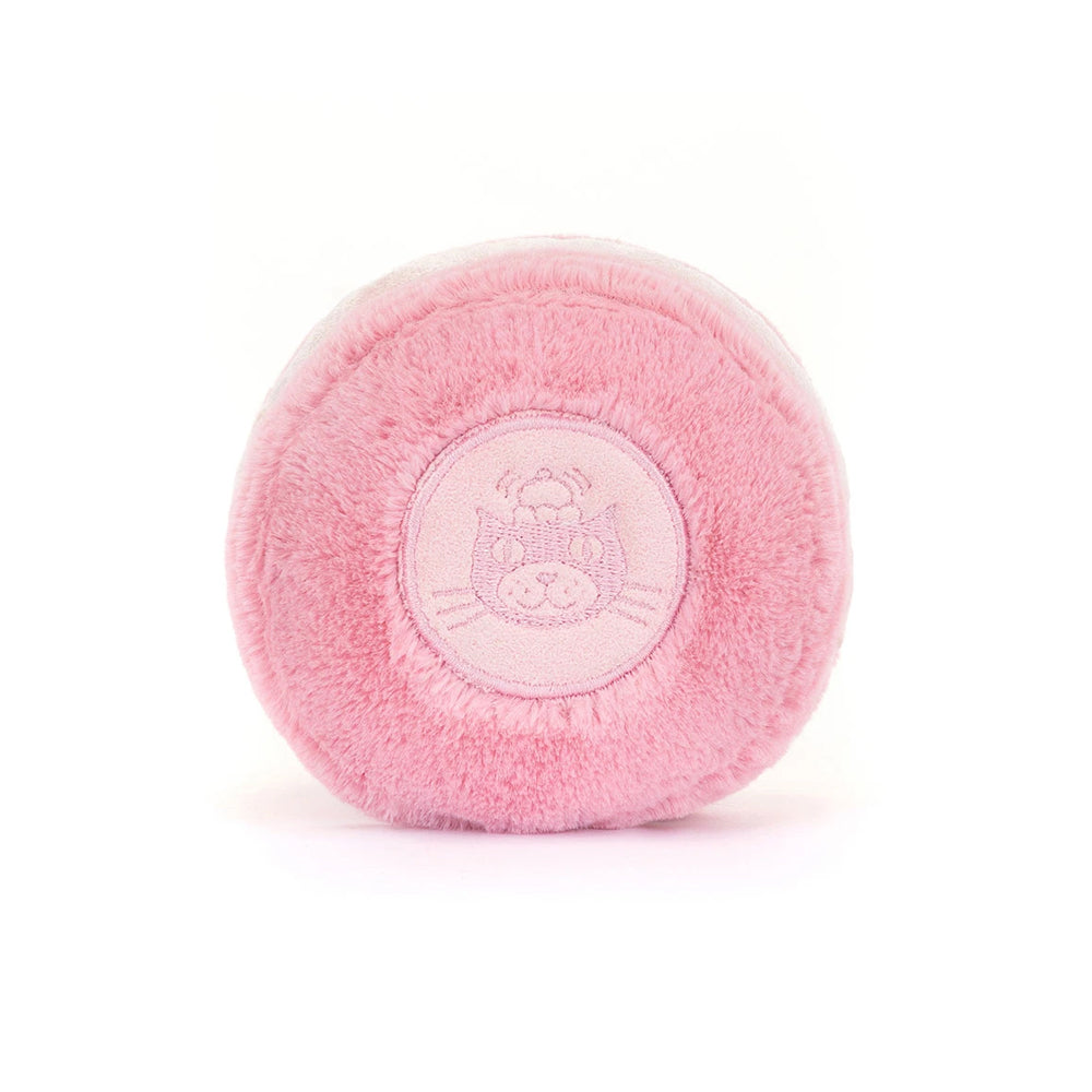 A round, plush macaron with a light pink embroidered cat face logo in the center, shown on a clean white background.