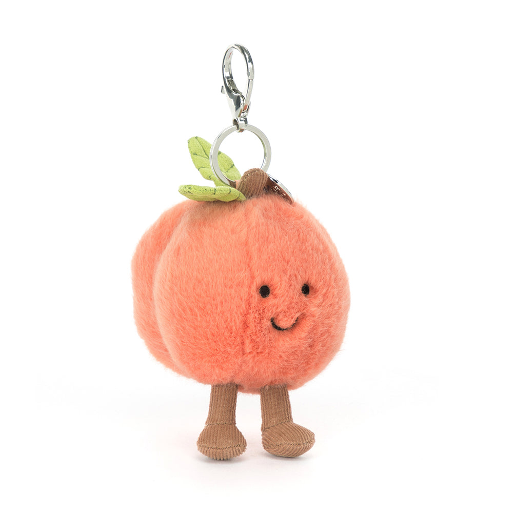 Plush peach character keychain with a white background