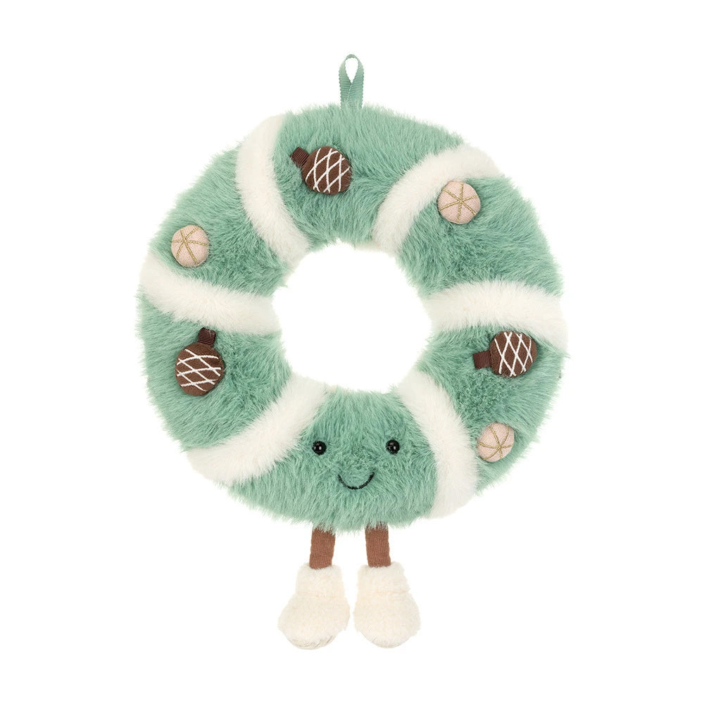 A plush wreath-shaped hanging decoration in mint green and white faux fur, with embroidered facial features, small brown acorn appliqués, and tan nut illustrations, shown on a plain white background.