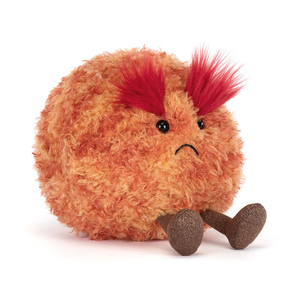 Plush toy resembling a round planet with red hair on a white background
