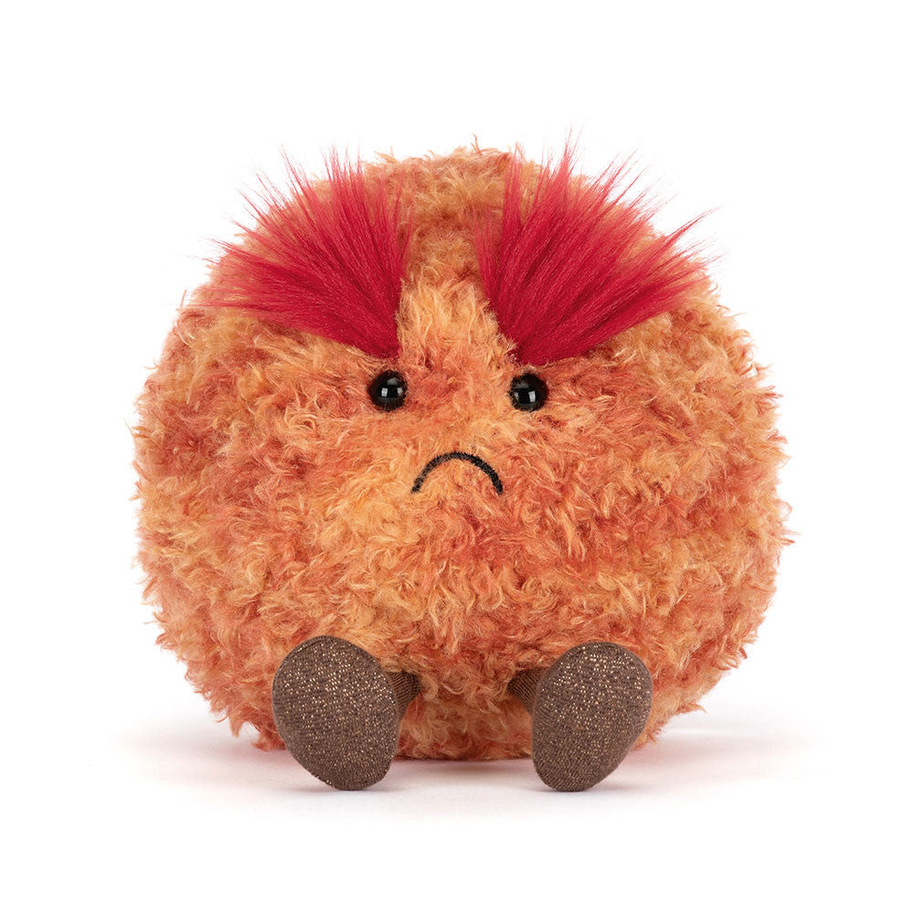 Plush toy resembling a planet  with red spikey eyebrows on a white background