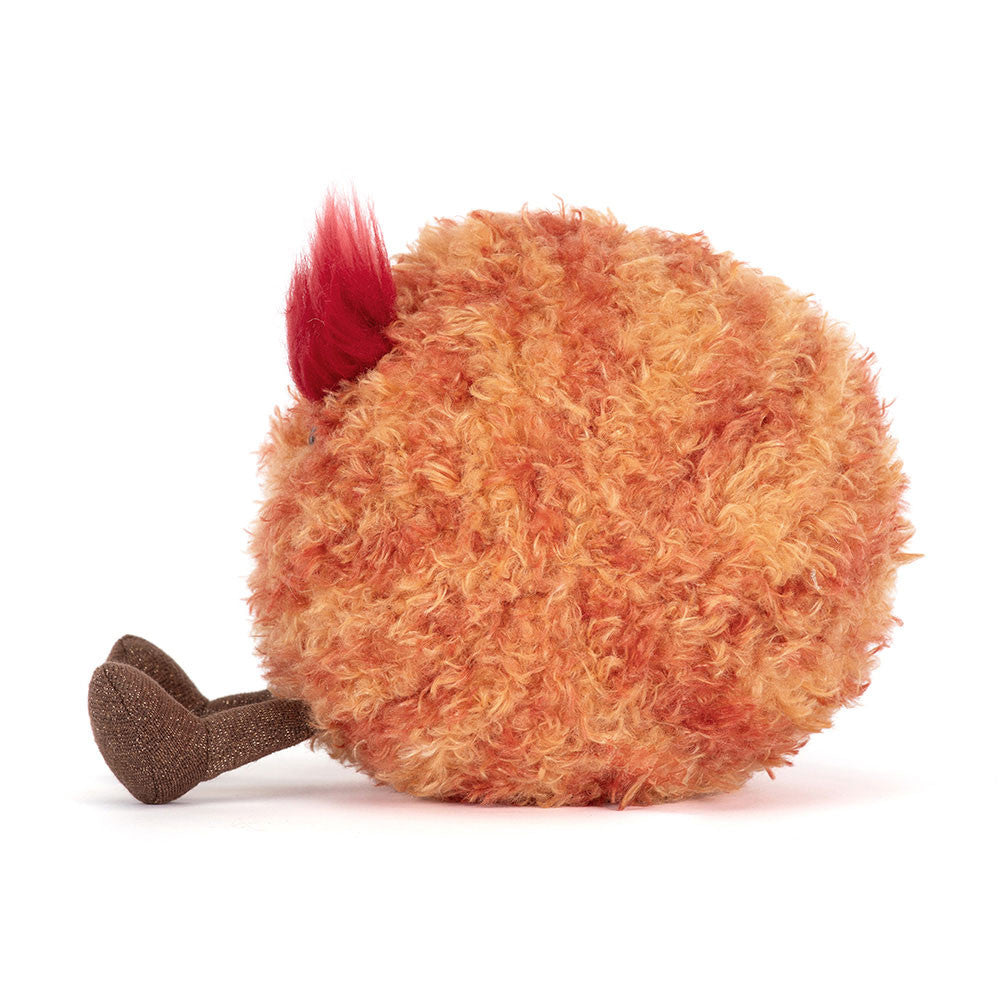 Plush toy resembling a fluffy planet with a red head on a white background