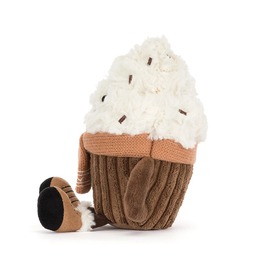 Side view; a plush Hot Chocolate toy with fluffy white whipped cream, a brown mug base, and a tan knit scarf, photographed on a clean white background.