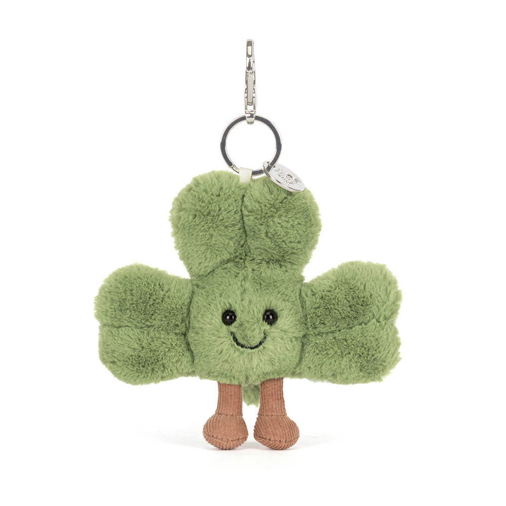 Green plush keychain with a smiling face on a white background