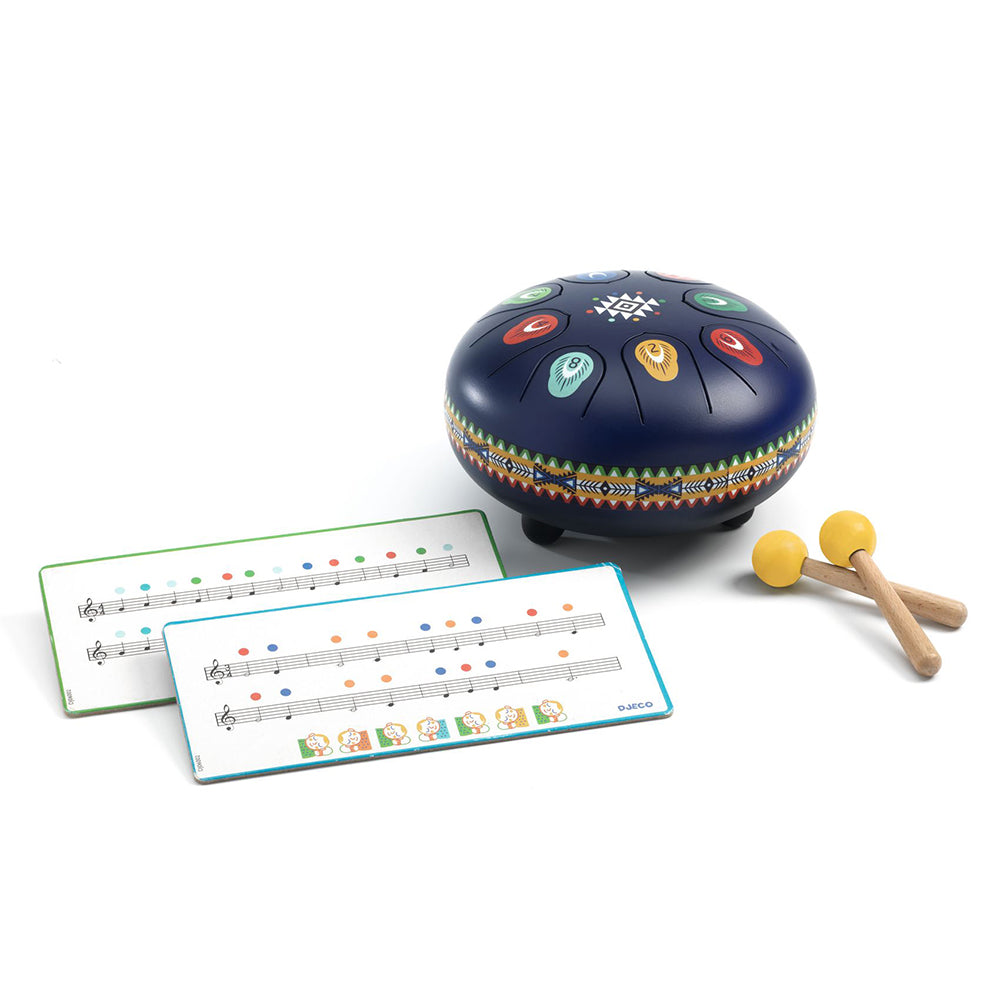 A handpan instrument set on a white background, featuring a dark blue handpan decorated with colorful geometric patterns, two instruction charts, and two wooden mallets with yellow balls.
