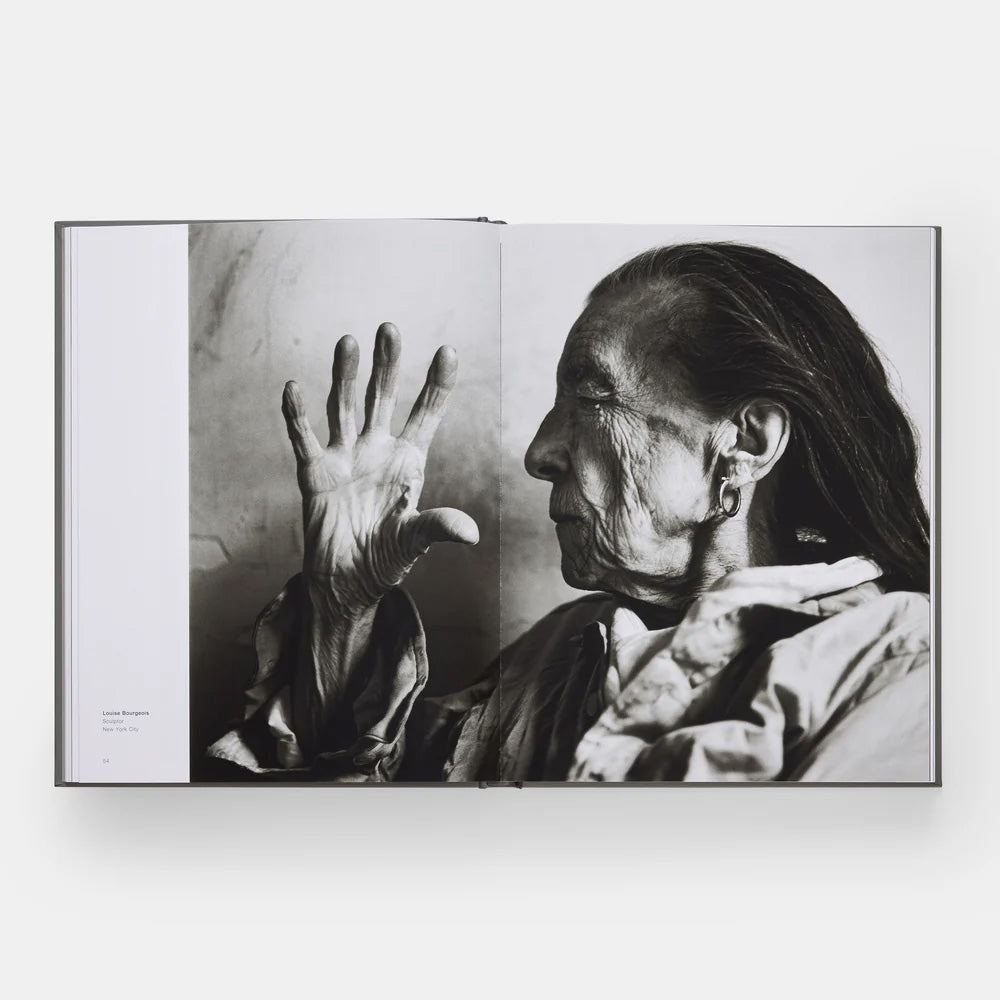 Black and white photograph of a person with a raised hand in an open book