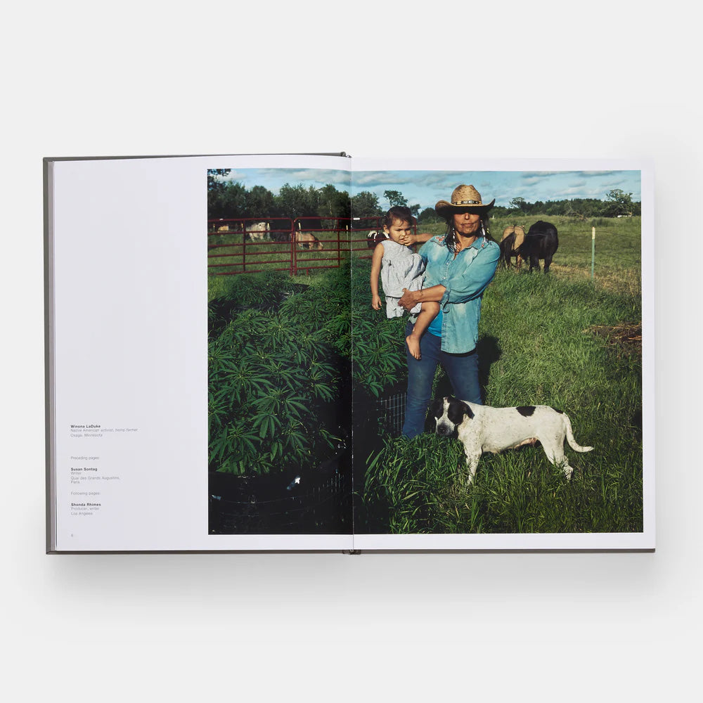 Book open to a page showing a woman with a child and a dog in a field.
