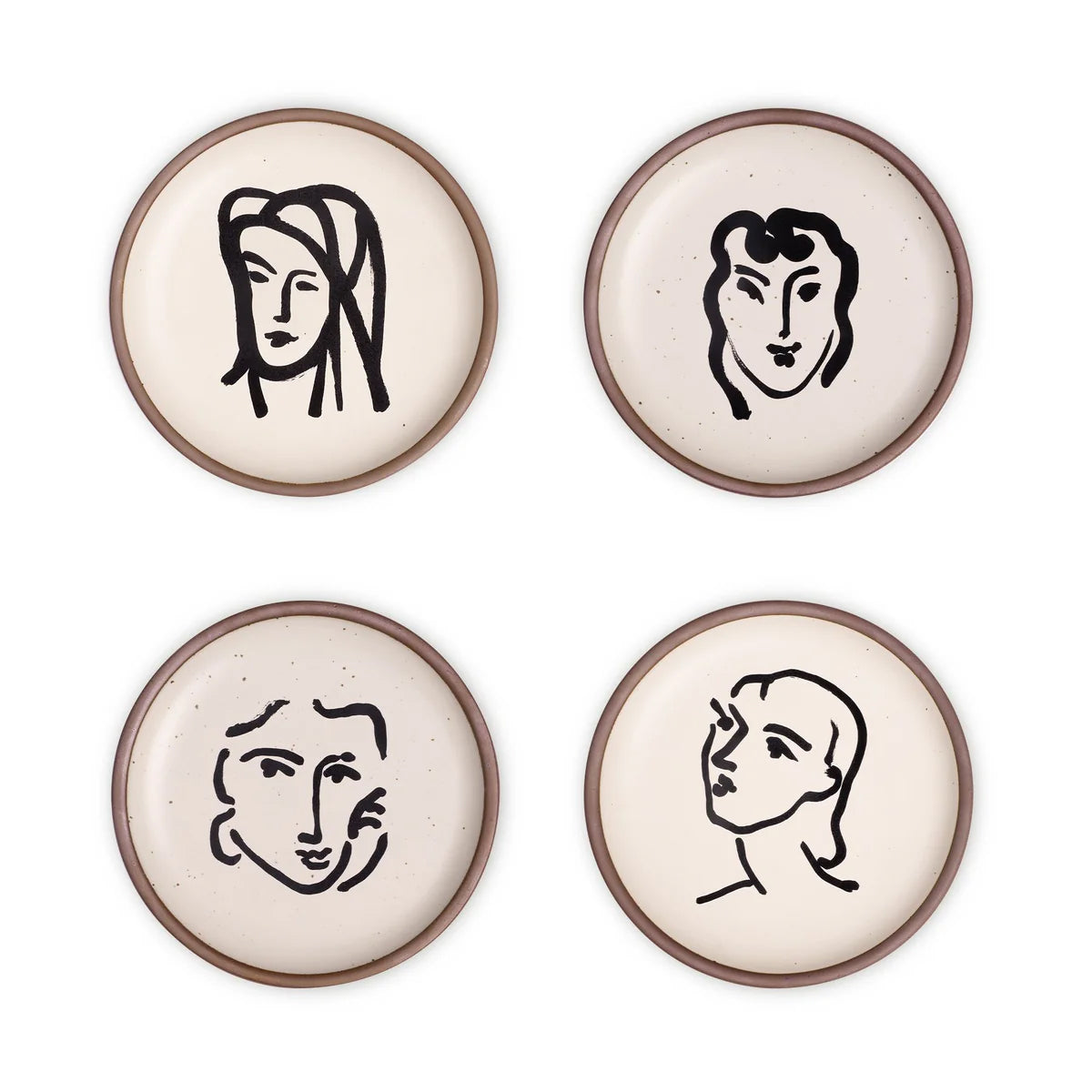 Four ceramic side plates with black line art faces on a white background