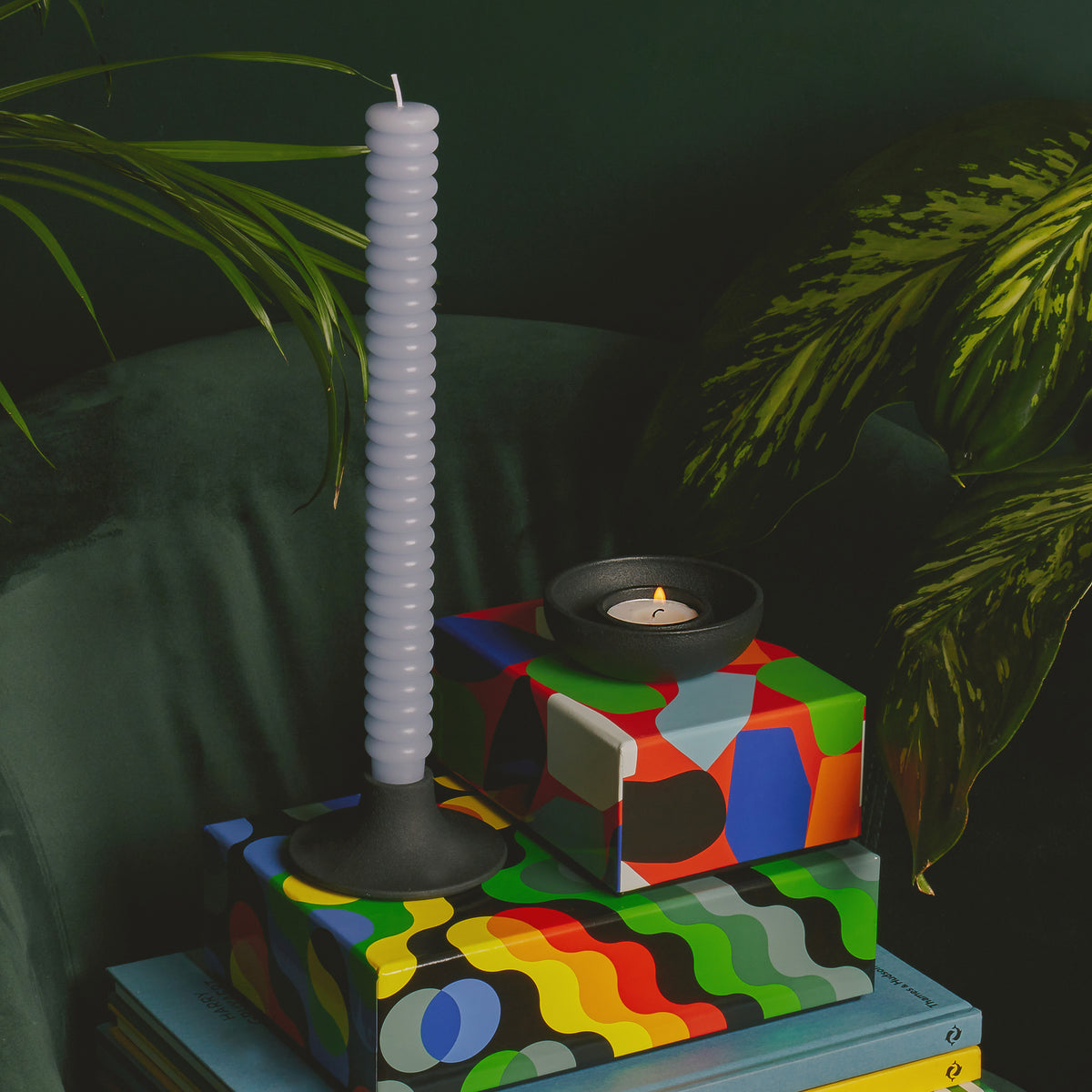 Candle holder with a white spiral candle on a dark background