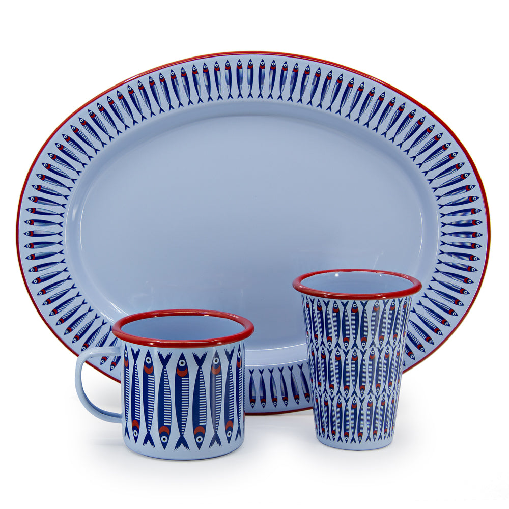 Ceramic platter and mugs with fish pattern on a white background