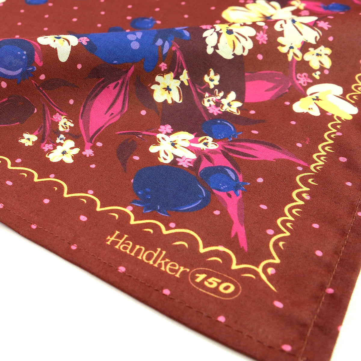 Handkerchief with floral design and 'Handker 150' text on a brown background