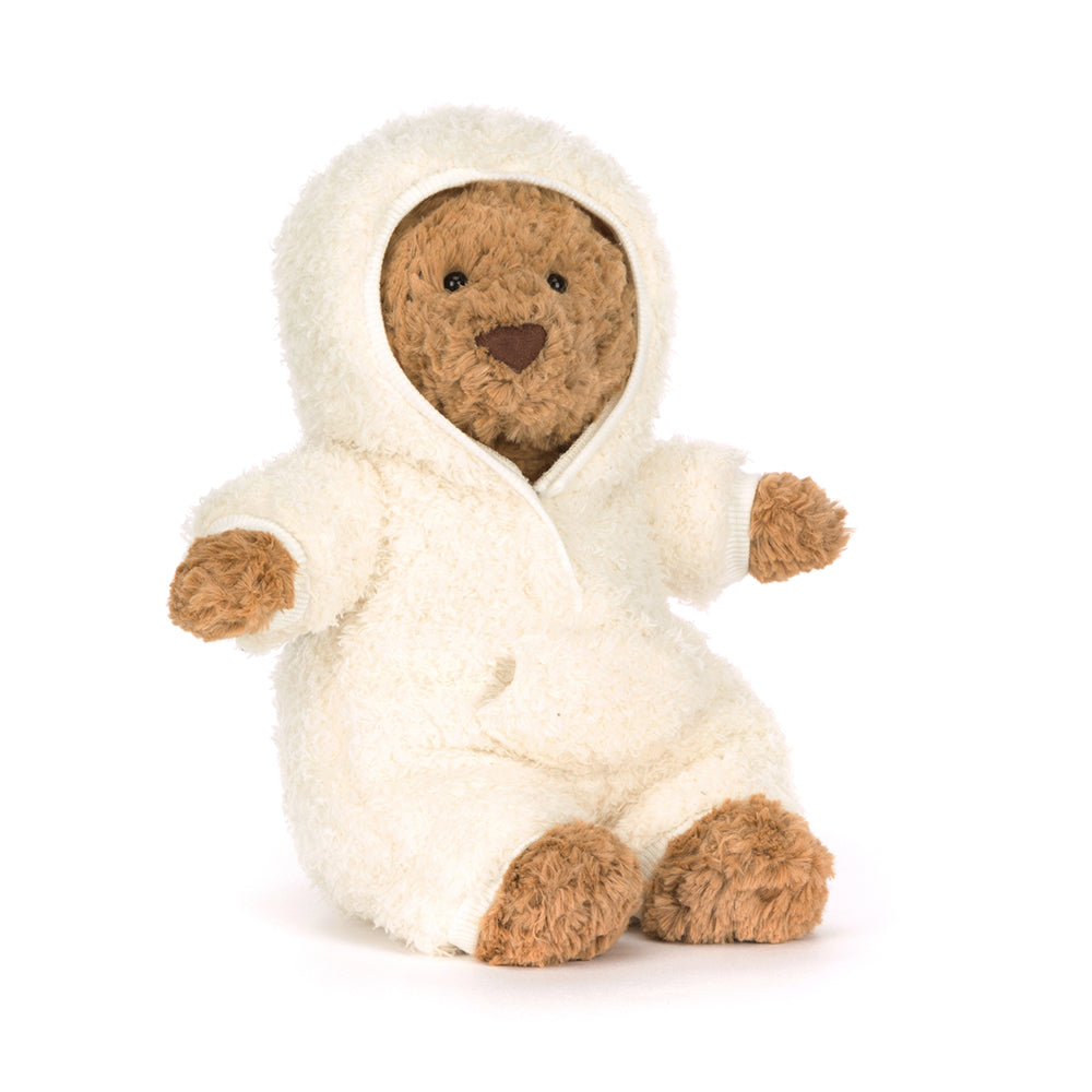 Stuffed bear in a white hooded onsie on a white background