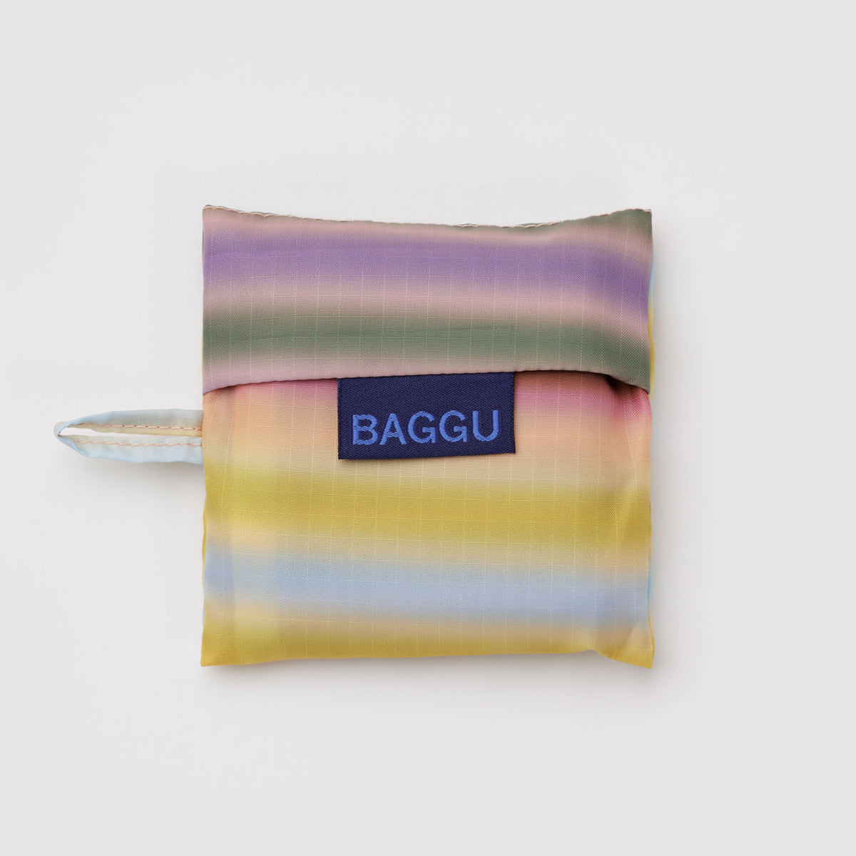 Multicolored striped reusable bag with 'BAGGU' label on a white background
