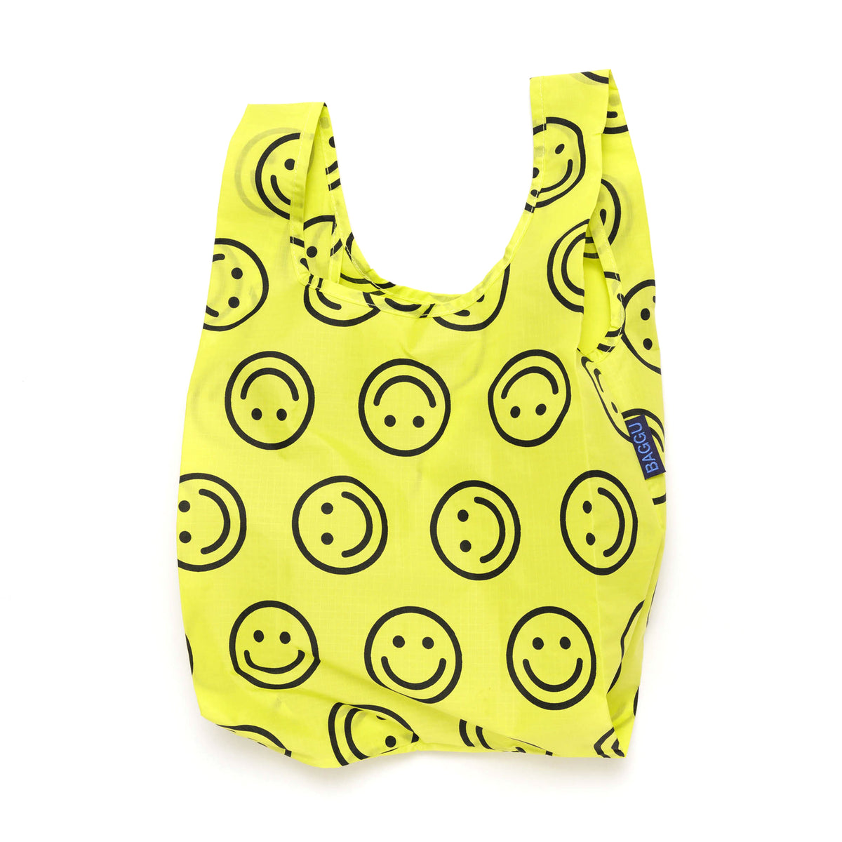 Yellow reusable bag with black smiley face pattern on a white background