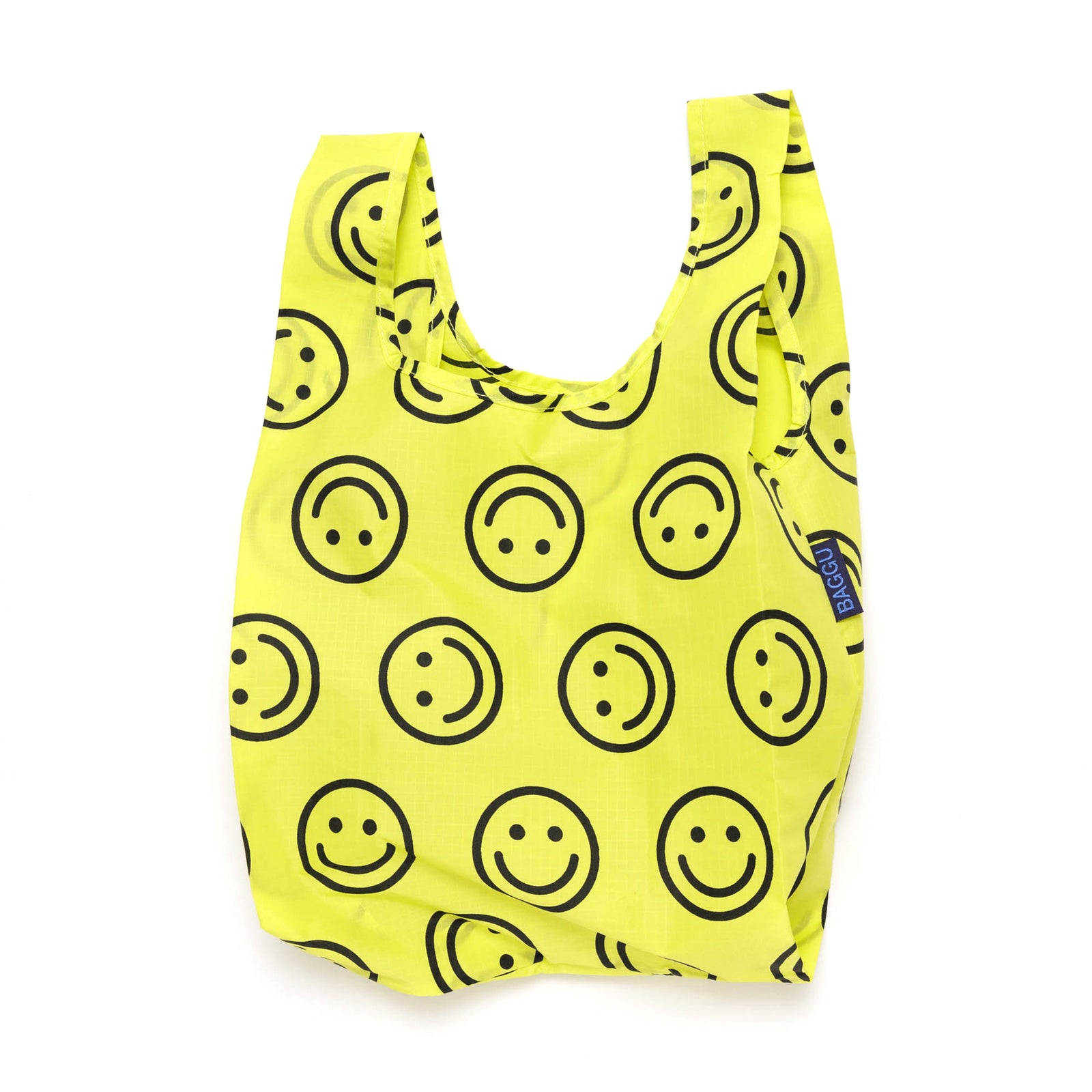 Yellow reusable bag with black smiley face pattern on a white background