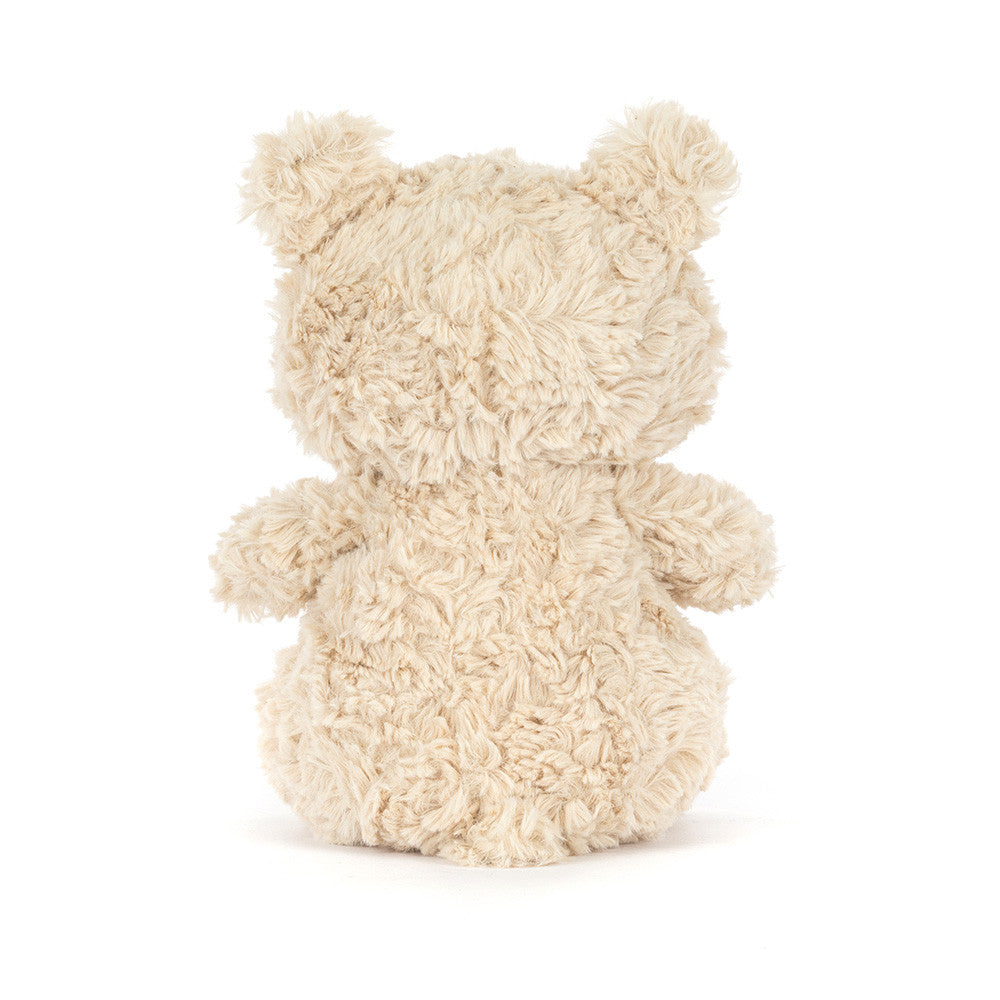 Fluffy beige teddy bear on a white background