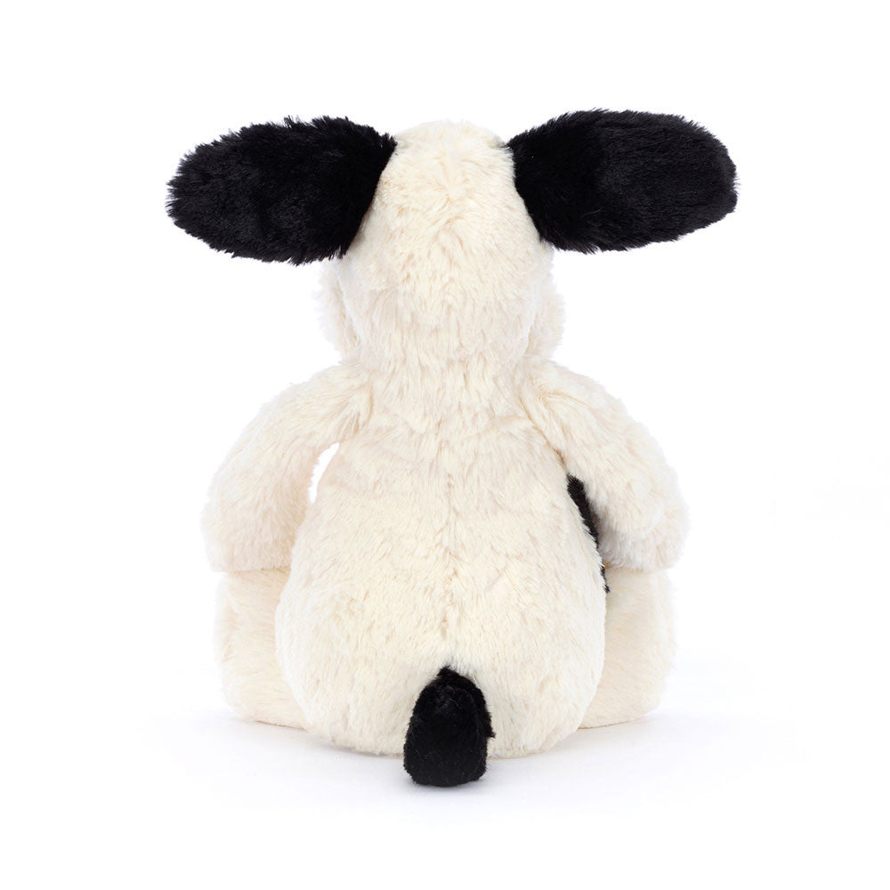 Rear view; white plush dog toy with black ears and tail on a white background