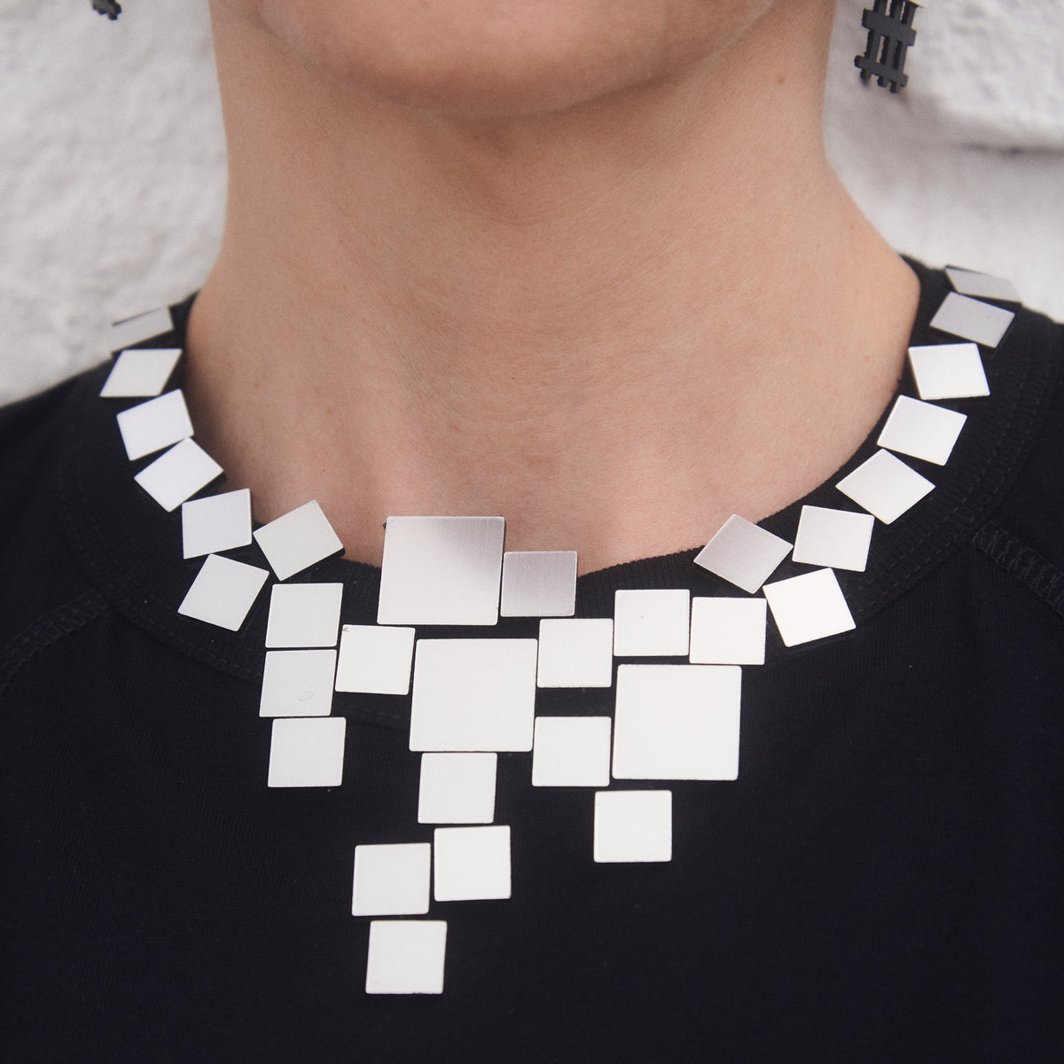 Model wearing Bauhaus V Necklace Silver Squares