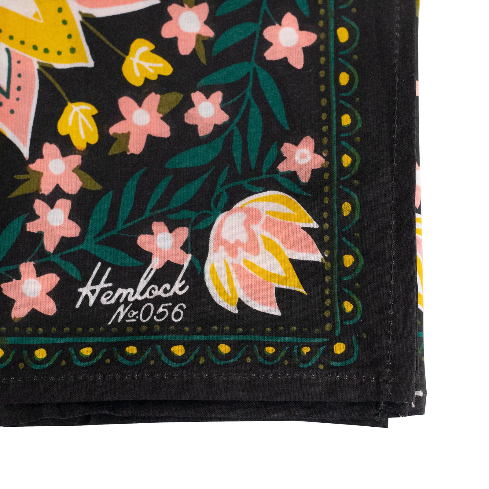 Floral patterned bandana with pink flowers and green leaves on a black background