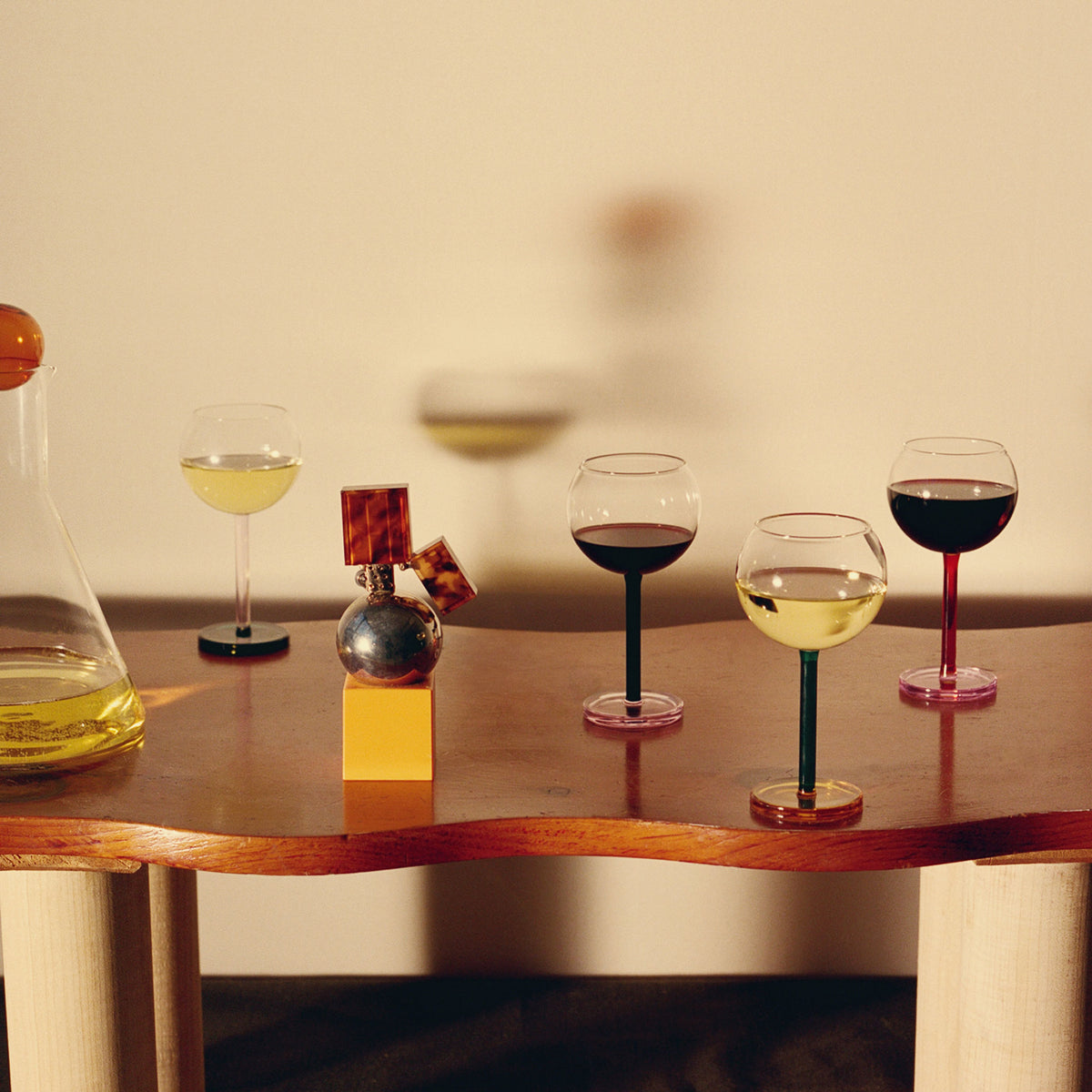 Wine glasses with different types of wine on a wooden table.