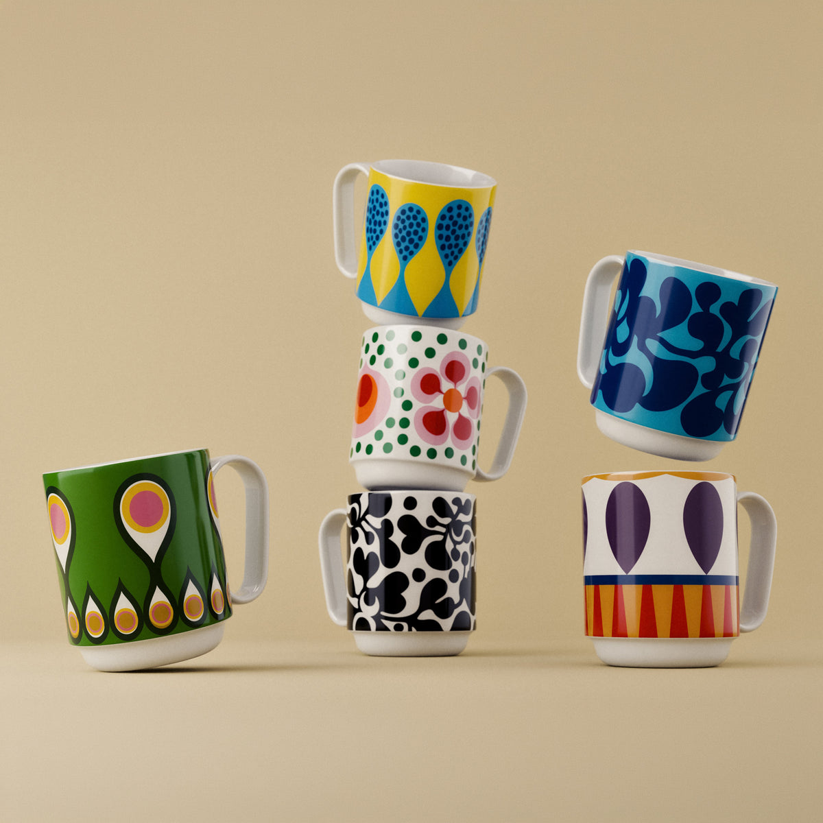 Six ceramic mugs with colorful retro patterns, arranged in a playful stack and balance display against a solid beige background.